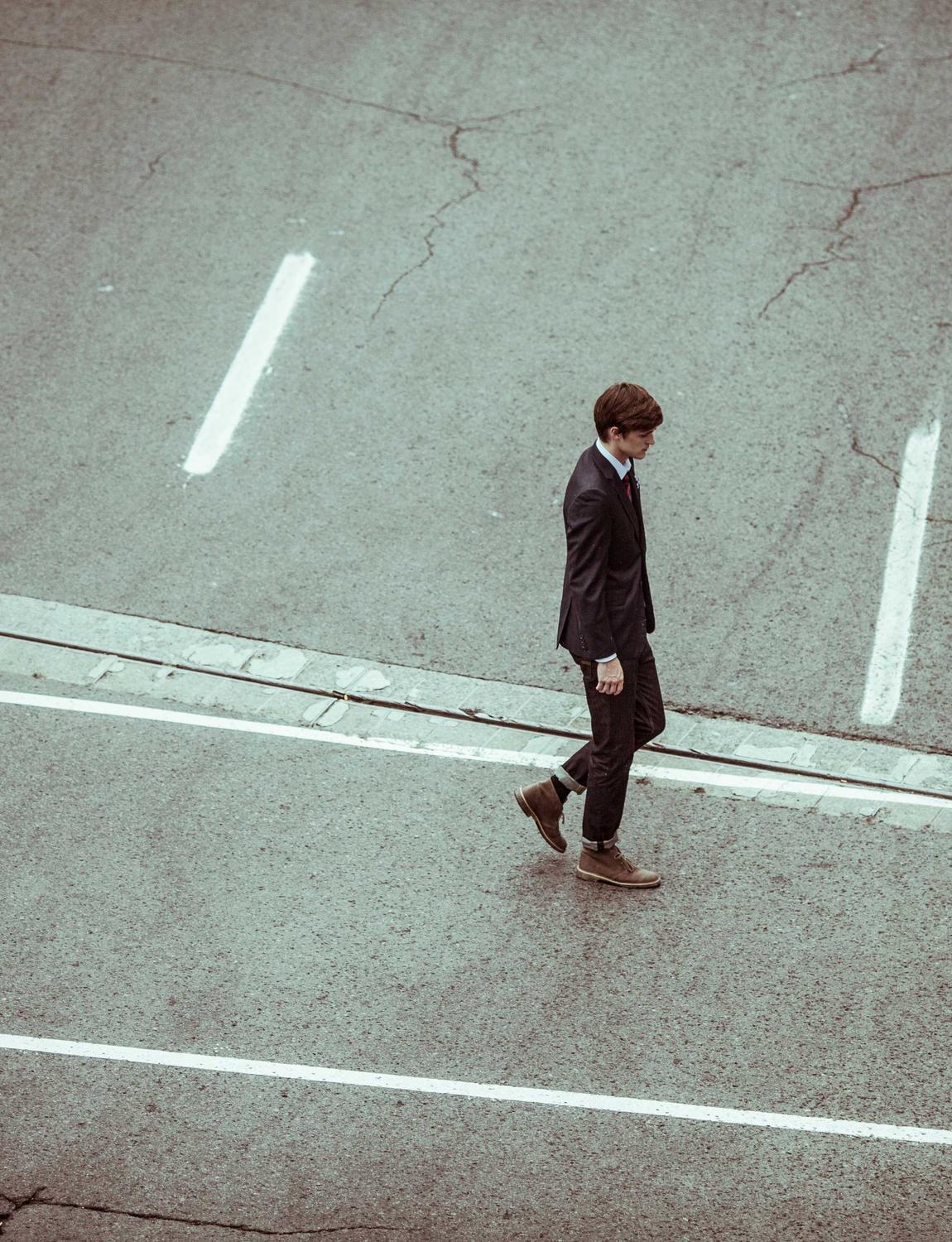 Person walking across an empty street